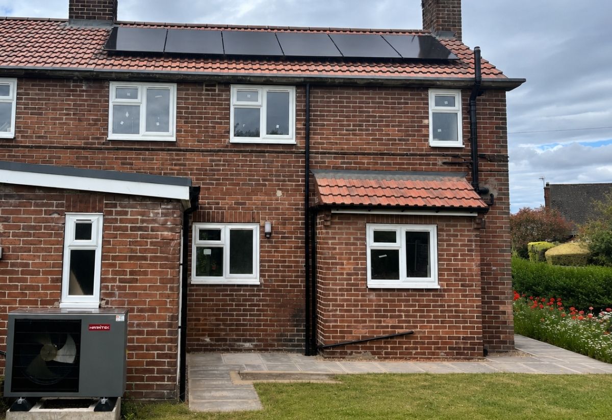 Rear view of the North Yorkshire council property showing rooftop solar and the external air-source heat pump